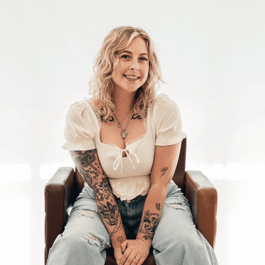 Portrait of Kourtney, a professional stylist at Sweet Peach, showcasing their expertise and style.